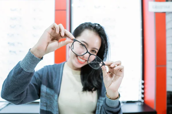 Una hermosa mujer sosteniendo una muestra de gafas —  Fotos de Stock