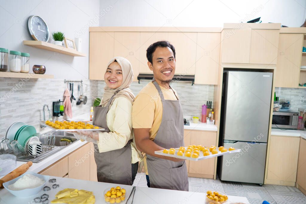 muslim couple making nastar snack cake together in the kitchen during ramadan