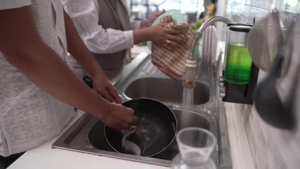 Feliz pareja lavar los platos juntos — Vídeo de stock