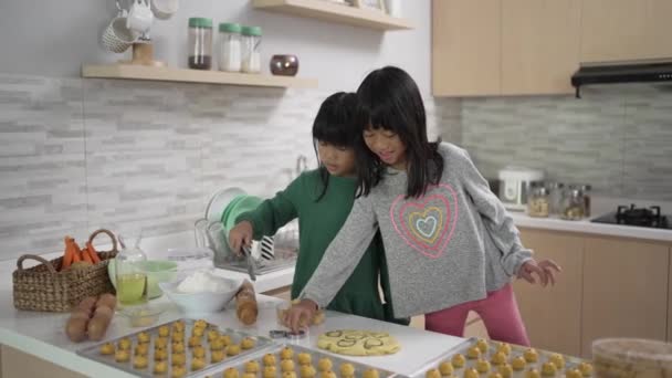 Két kislány nasztár tortát süt együtt. — Stock videók