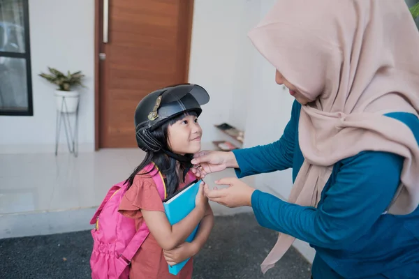 Mère asiatique attacher son casque fille avant d'aller à l'école — Photo