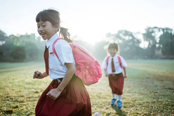 Liten flicka student kör tillsammans när du går till deras skola — Stockfoto