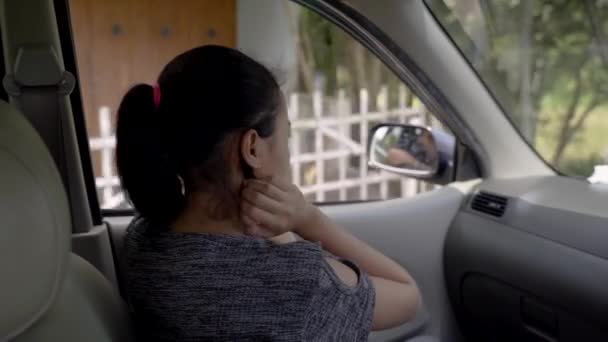 The teenage girl looks outside while sitting in the car with the windows open — Stock Video