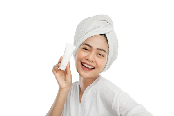 Happiness beautiful girl with towel on head holding tube bottle — Stock Photo, Image