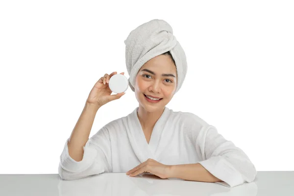 Beautiful asian girl with towel on head holding cream pot bottle — Fotografia de Stock