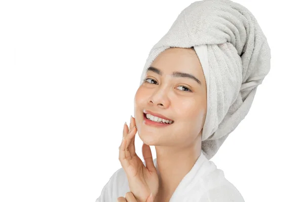 Attractive girl with bath towel on head smiling with hand holding chin — Stock Photo, Image