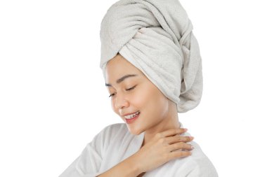 beautiful girl with bath towel on head with hands beside neck