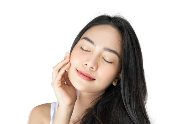 Beautiful woman with long black hair closes her eyes with finger pose gently holding cheek — Stock Photo, Image