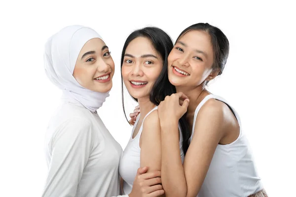 Smiling a veiled girl and two asian young girl laughing and hugging — Foto Stock