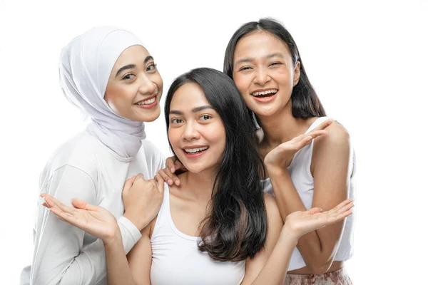 Three affectionate woman smiling with present something hands gesture — Fotografia de Stock