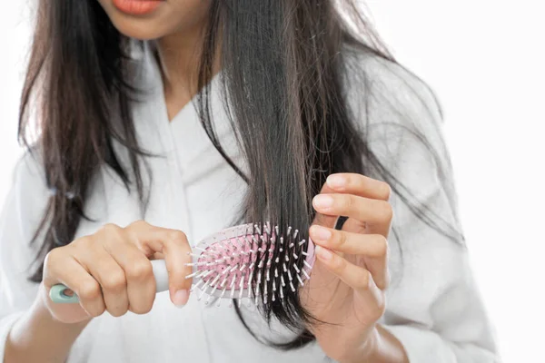 Close up of a woman using comb with with tousled hair —  Fotos de Stock