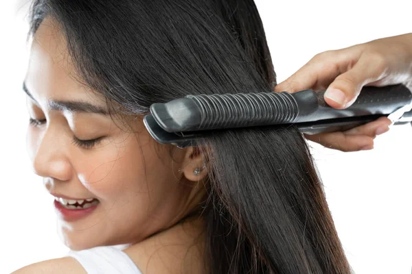 Close up of beautiful girl using a hair straightener —  Fotos de Stock