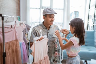 father shopping with his little girl in small boutique shop