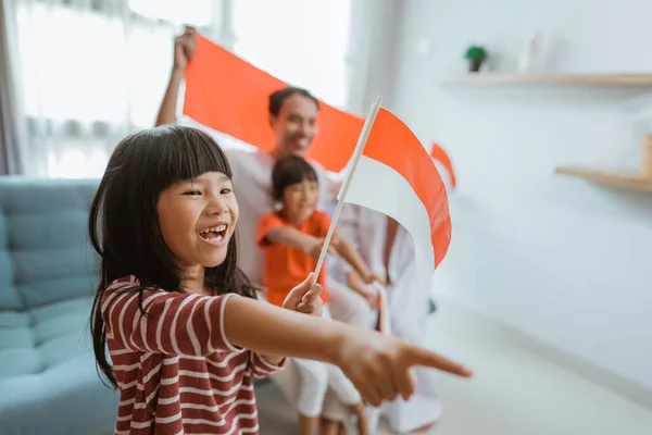 Excited indonesian little girl supporter while watching sport match at television — Stok Foto