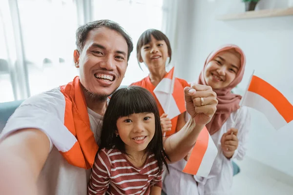 Indonesian muslim asian family making selfie and video call using their phone at home — Zdjęcie stockowe