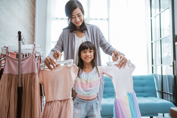 mom and kid choose beautiful dress