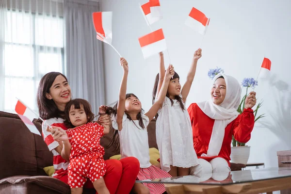 Excited indonesian family supporter while watching sport match at television at home — Zdjęcie stockowe