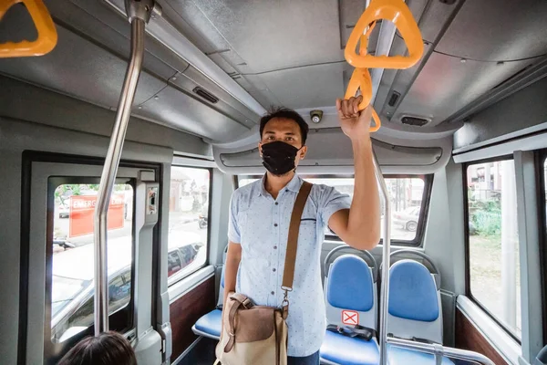 asian employee wearing mask for protection in public transport. Passengers in tram