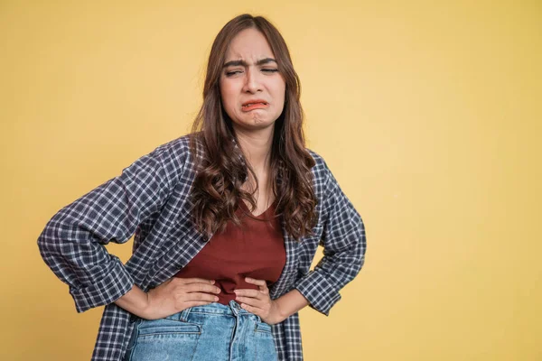 Woman holding stomach with both hands with pain expression — Stock Photo, Image