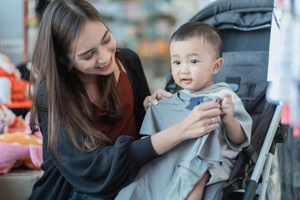 アジア系の母親と赤ちゃんの店での子供の買い物 — ストック写真