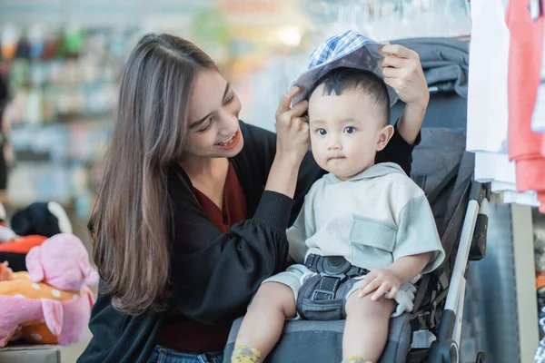 Ásia mãe com ela criança menino compras no o bebê loja — Fotografia de Stock