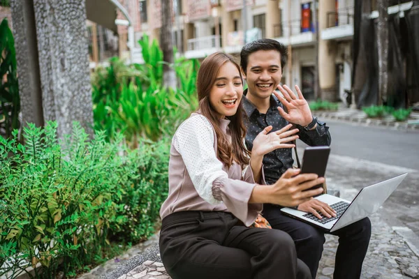 Happy woman using a smart phone taking selfie and video call with her partner — Stock Fotó