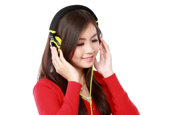 Pretty young girl enjoys listening music — Stock Photo, Image