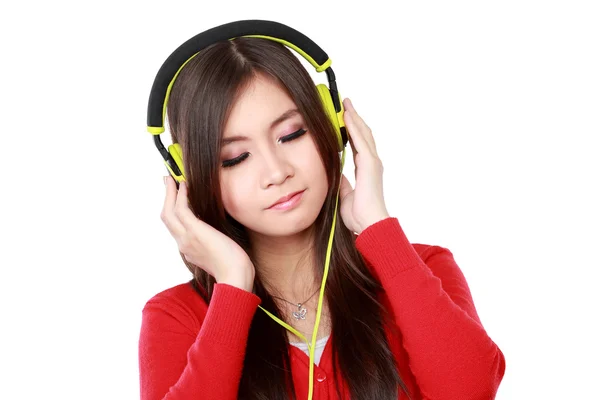 Pretty young girl enjoys listening music — Stock Photo, Image