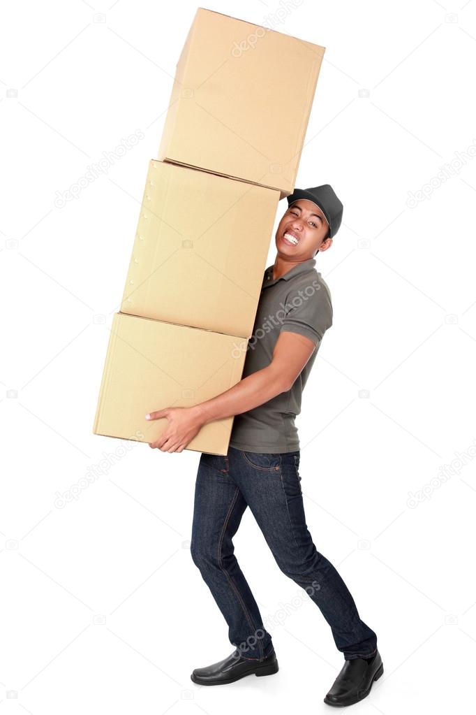 Man Holding some heavy Stack Of Cardboard Boxes