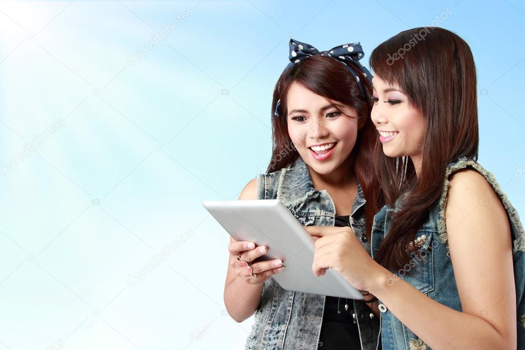 young girl friend using tablet