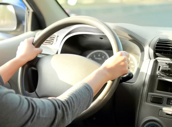 Woman with her hand on the wheel steering — Stock Photo, Image