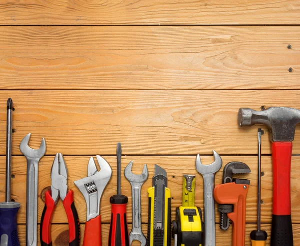 Set of tools over a wood panel — Stock Photo, Image