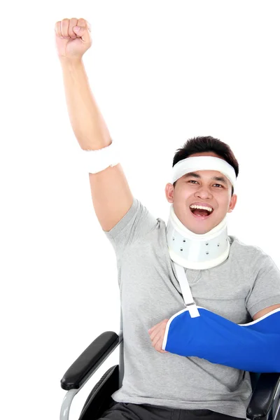 Cheerful injured young man raise his hand — Stock Photo, Image