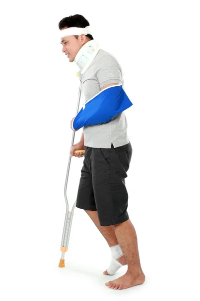 Young man with broken leg on crutch — Stock Photo, Image