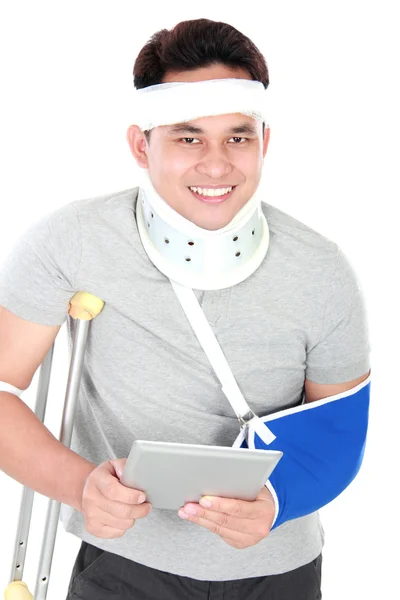 Injured young man play gadget — Stock Photo, Image