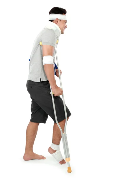 Young man with broken leg on crutch — Stock Photo, Image