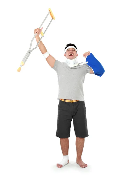 Injured young man hold up his crutch — Stock Photo, Image