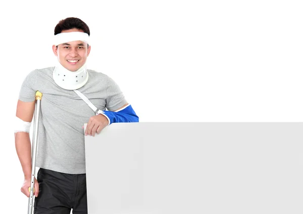 Injured young man holding grey board — Stock Photo, Image