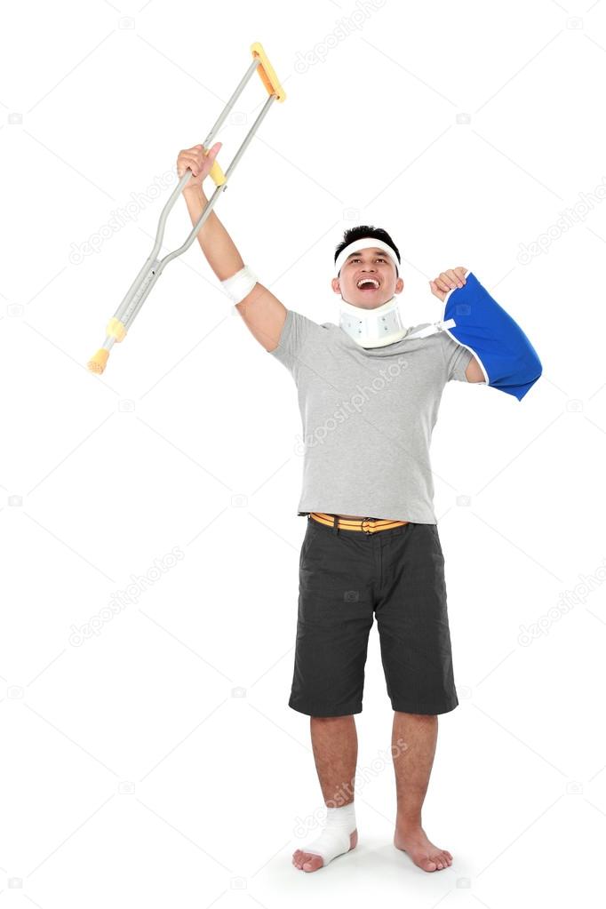 injured young man hold up his crutch