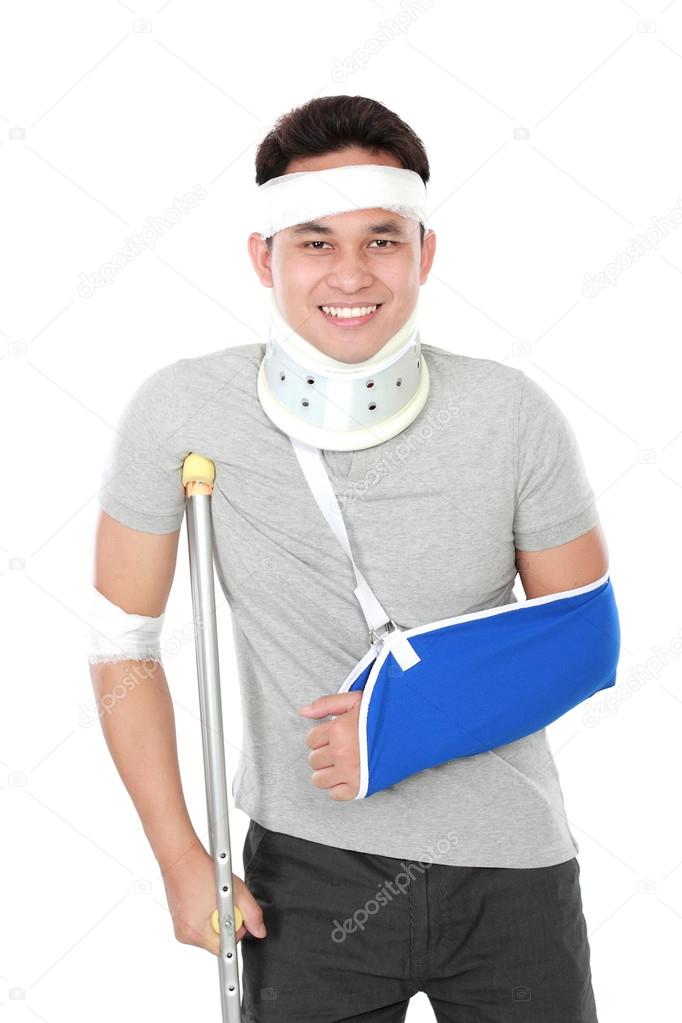 injured young man wear arm sling and crutch
