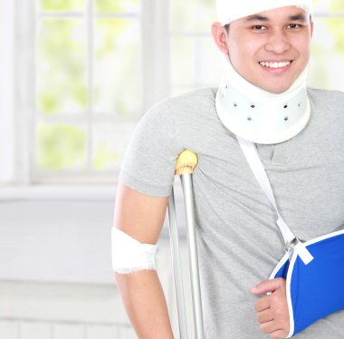 injured young man use crutch and arm sling clipart
