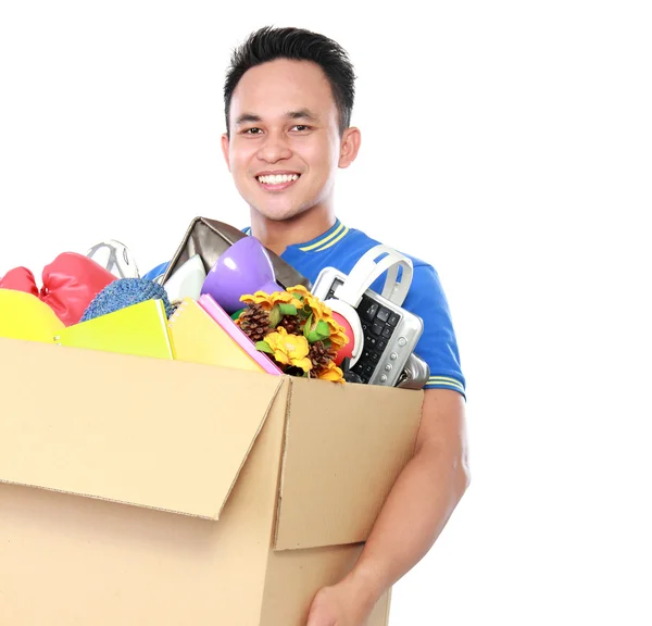 Young man carrying box full of stuff — Stock Photo, Image