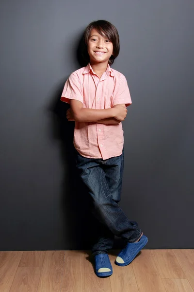 Cool liten pojke poserar med arm korsade — Stockfoto
