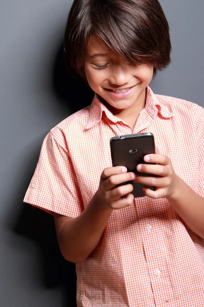 Junge genießen spielen ein handyphone — Stockfoto
