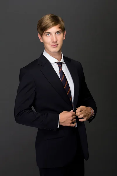 Young man buttoning the blazer — Stock Photo, Image
