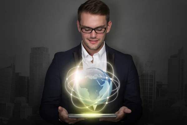 Young businessman with a tablet on his hand — Stock Photo, Image