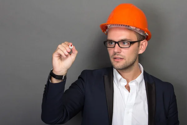 Young businessman wear a safety helmet, writing — Stock Photo, Image