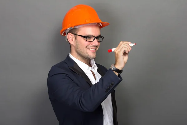 Young businessman wear a safety helmet, writing — Stock Photo, Image