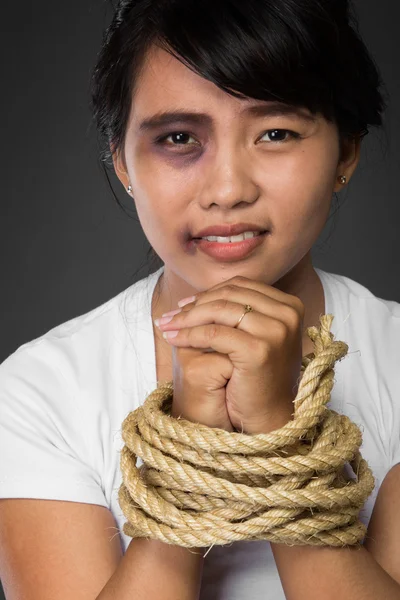 Mulher com as mãos amarradas com corda sendo abusada — Fotografia de Stock