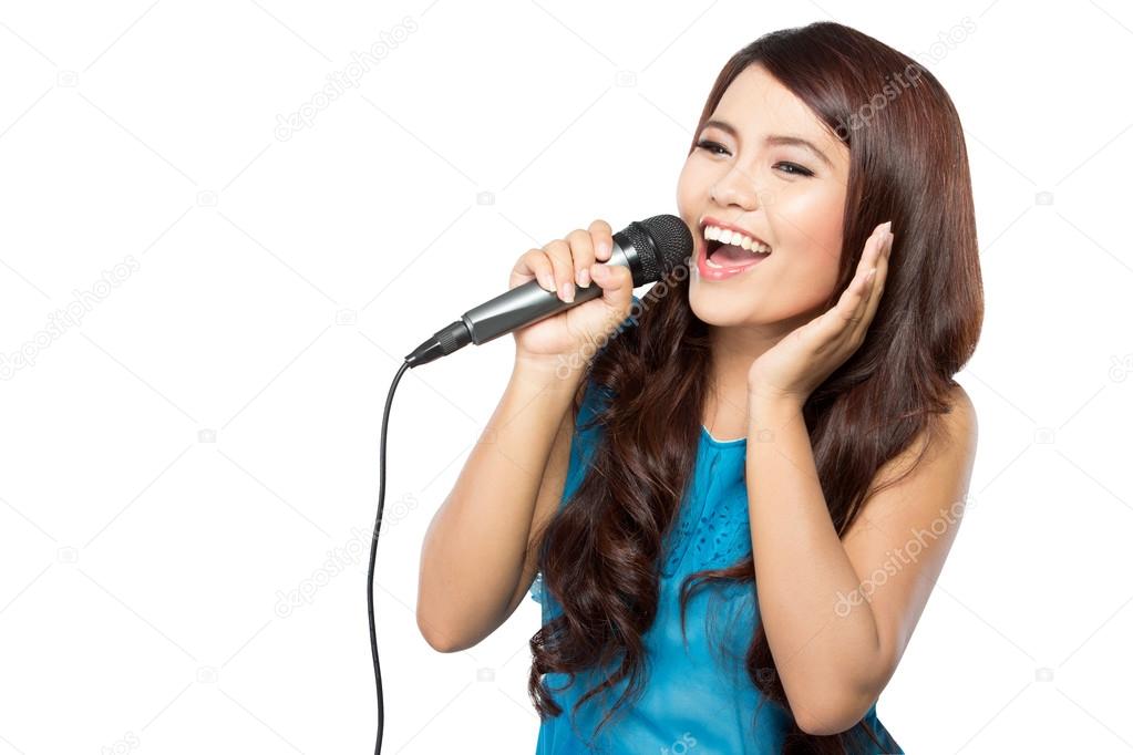 Young woman sing holding a mic, isolated